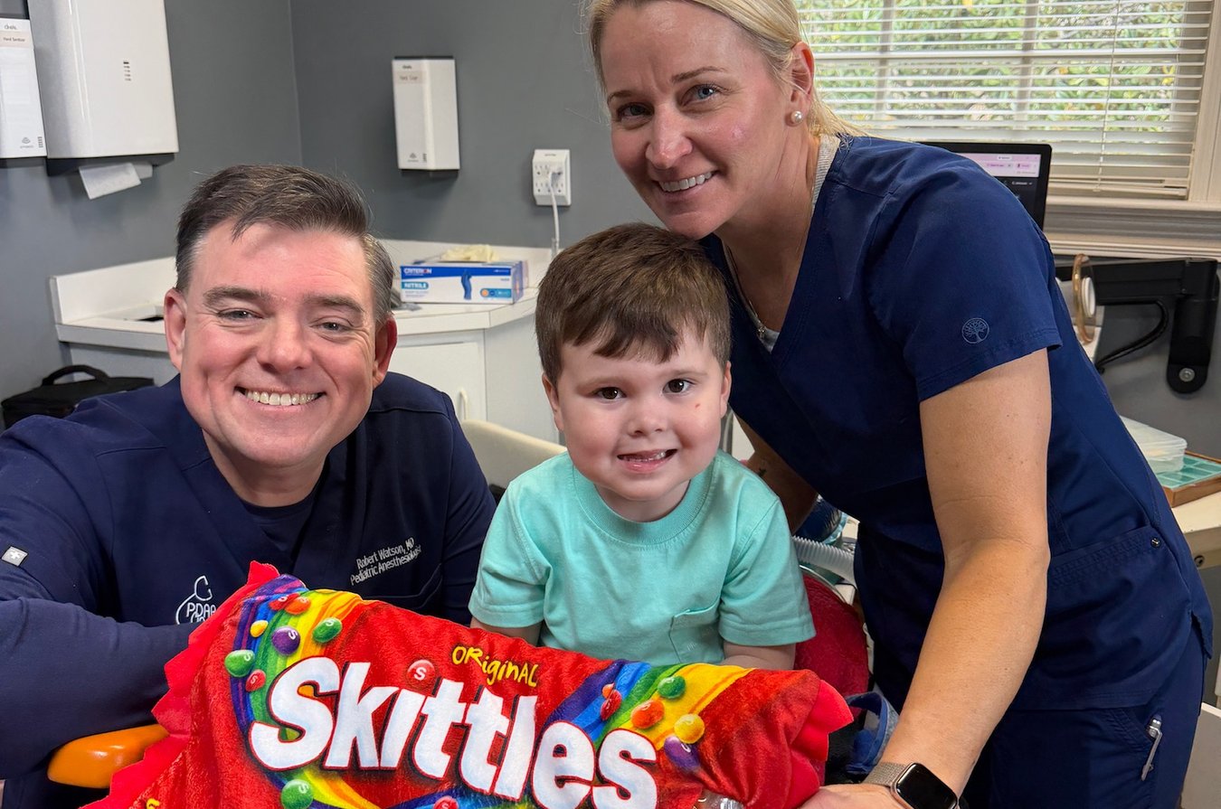 Anesthesiologist and team member with a young patient at Thomas & Moore Pediatric Dentistry