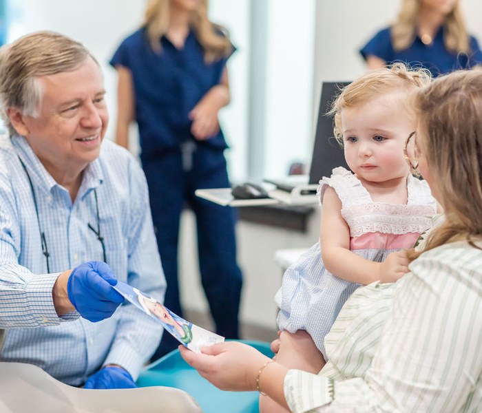 Team member greeting a young patient