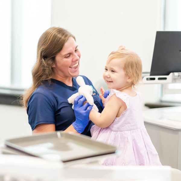 Hygienist playing with a toddler patient