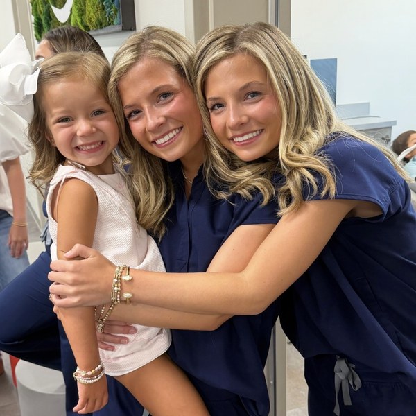 Two team members holding a young patient