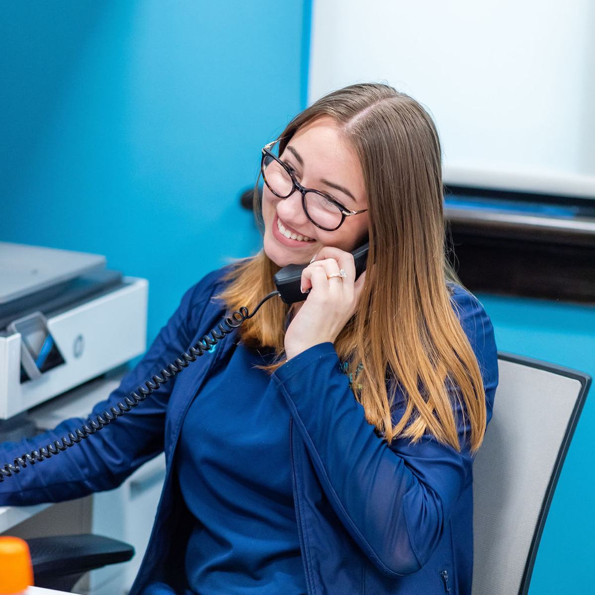 Team member at Thomas & Moore Pediatric Dentistry answering the phone