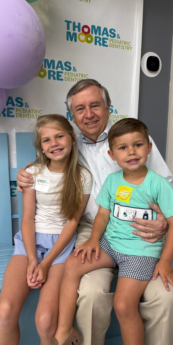 Dr. Thomas with two young patients at Thomas & Moore Pediatric Dentistry
