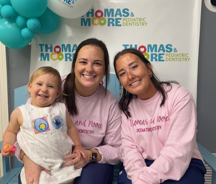 Thomas & Moore Pediatric Dentistry team members with a young patient